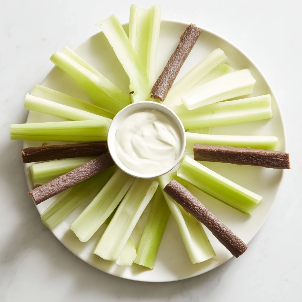 Delicious Rustic Wheel appetizer, an easy-to-make platter with fresh celery and savory meat snacks.