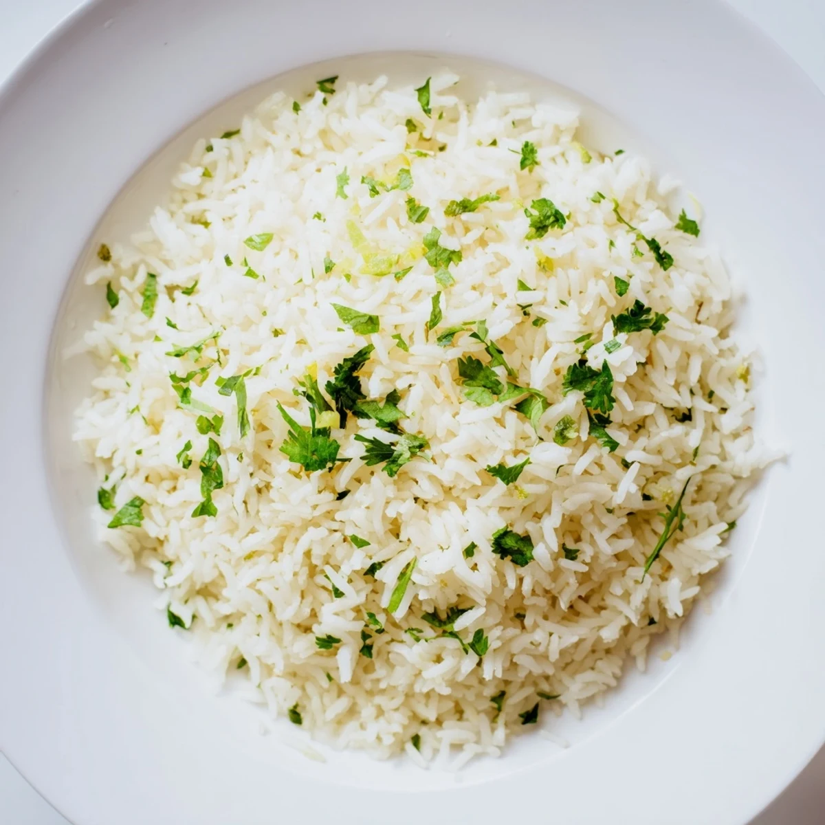 Steaming bowl of cilantro lime rice, infused with lime zest, and ready for serving tonight.