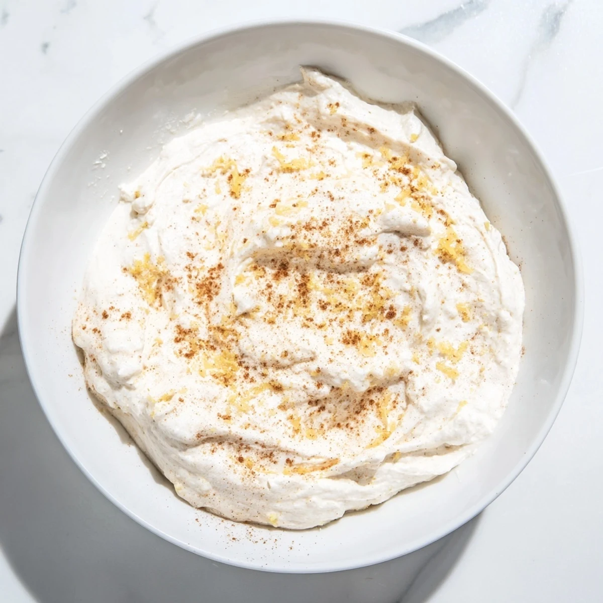 Greek Yogurt Fruit Dip, creamy and sweet, served alongside vibrant, colorful fruit skewers for a party.