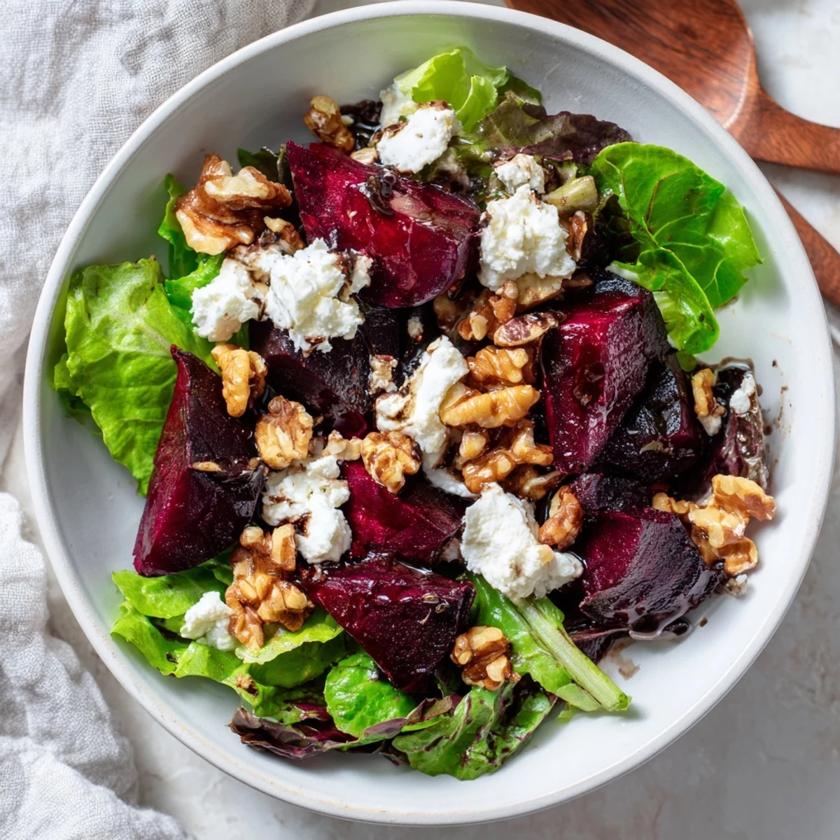 Beet and goat cheese salad with vibrant roasted beets, creamy goat cheese, nuts, and balsamic dressing.