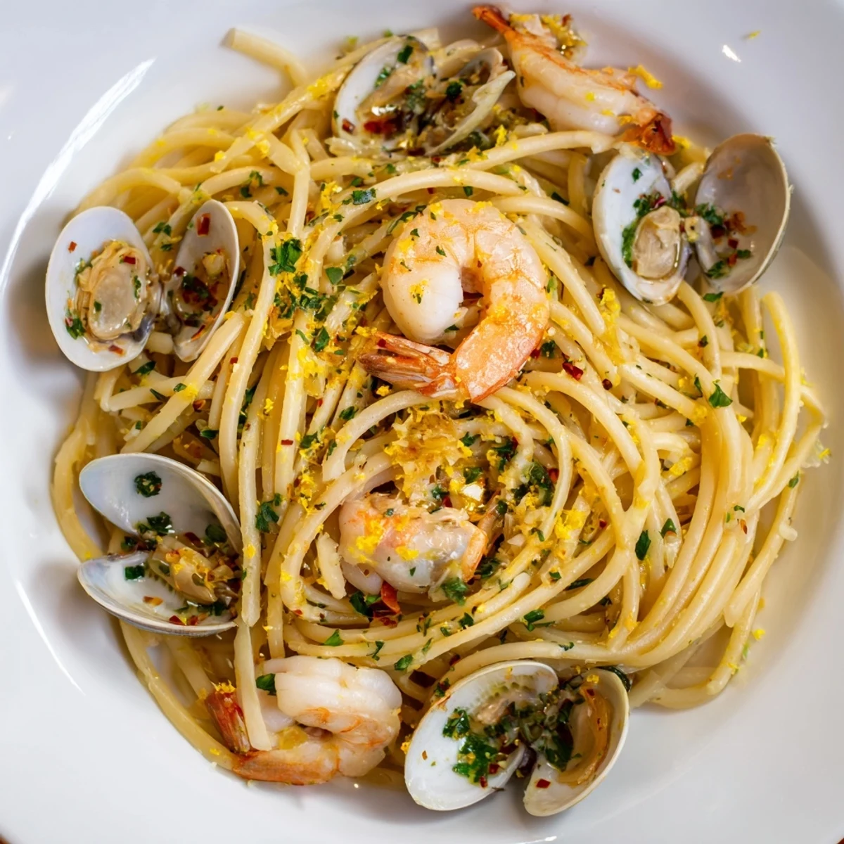 Seafood Pasta Aglio e Olio in a skillet with shrimp, clams, and garlic, ready to serve.