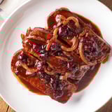 Hearty Vegan Sauerbraten with a rich, dark gravy, perfect for a special meal.
