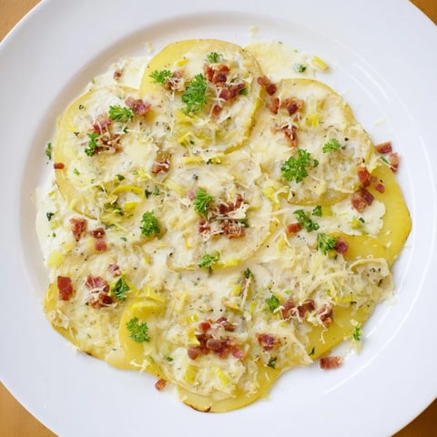 One-Pan German Potato & Leek Bake, a creamy, golden casserole with crispy bacon and melted cheese.