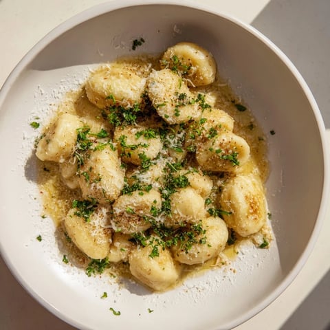 Golden potato dumplings with Parmesan-Garlic Brown Butter, served warm with extra cheese.