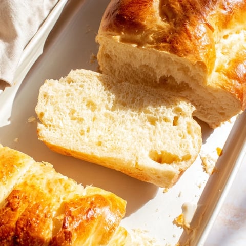 Golden-crusted Beer Bread Family Loaf, perfect for tearing apart and enjoying with melted butter.