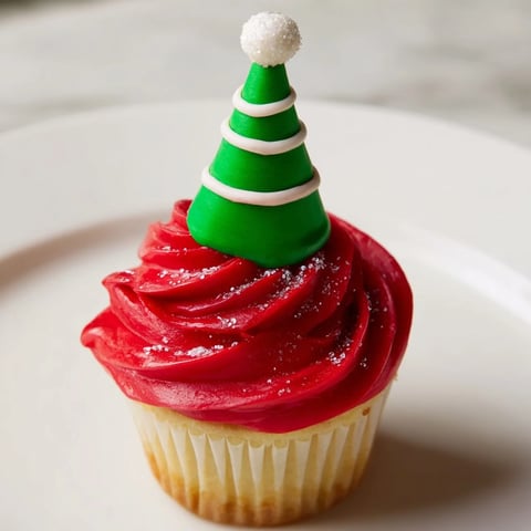 A whimsical tower of Elf Hat Cupcakes, a colorful and festive holiday dessert.