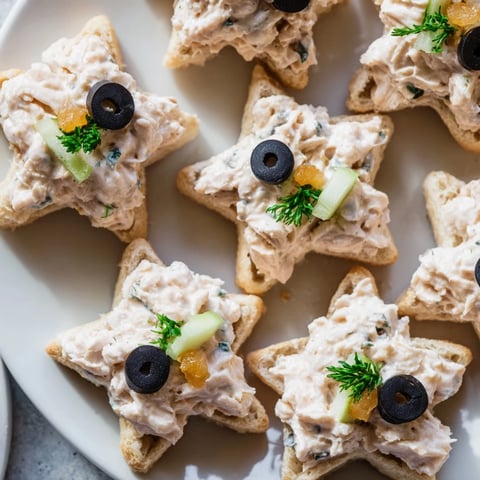 Mini Starfish Sandwiches shaped with tuna filling and olive eyes, perfect party appetizers.