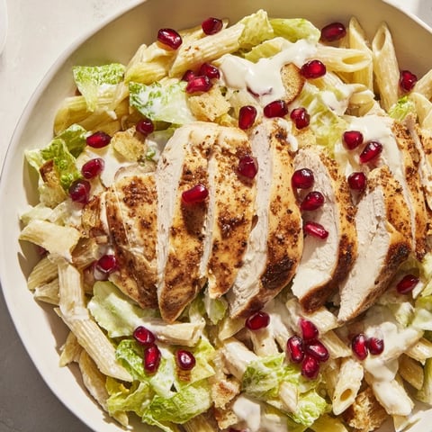 Chicken Caesar Pasta with Pomegranate, a vibrant dish with juicy chicken and ruby-red pomegranate.
