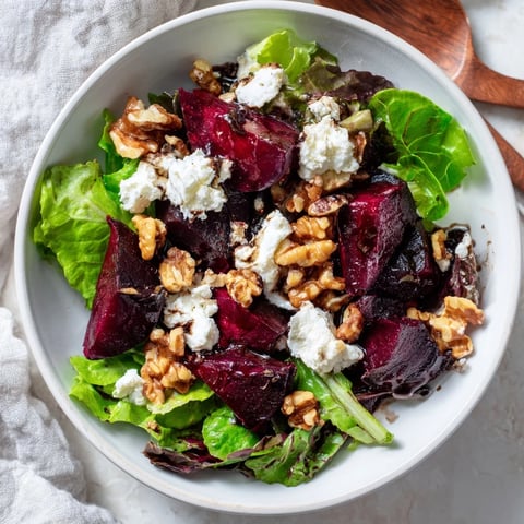 Beet and goat cheese salad with vibrant roasted beets, creamy goat cheese, nuts, and balsamic dressing.