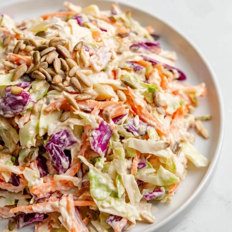 Bright, colorful crunchy coleslaw salad, with crisp cabbage and a creamy dressing, ready to enjoy.