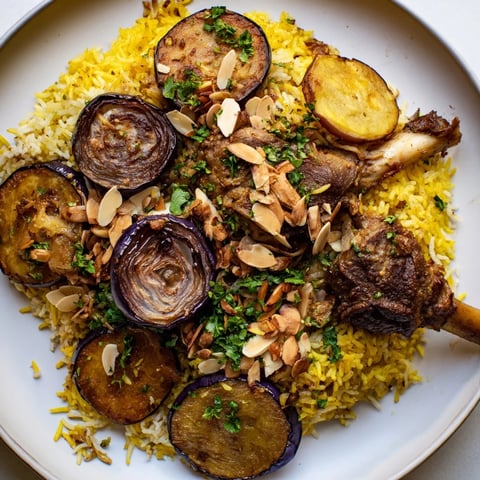 Aromatic layers of tender meat, fluffy rice, and vegetables compose this beautiful Palestinian Maqluba dish.