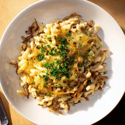 Golden-crusted cheesy spaetzle skillet, showing tender spaetzle and perfectly melted cheese.