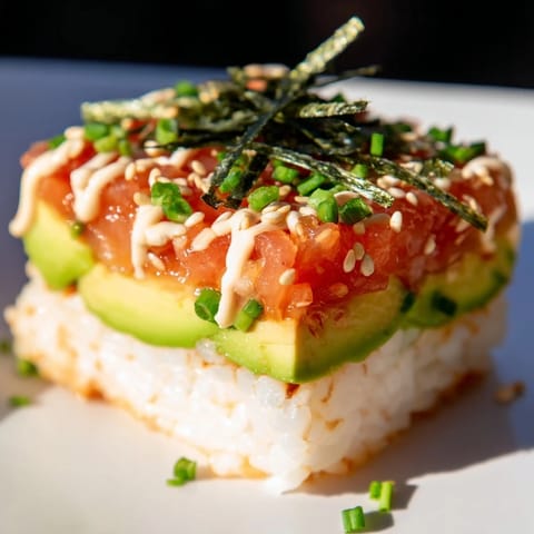 Crispy rice salmon stacks, with fresh salmon, spicy mayo, and a sprinkle of sesame seeds.