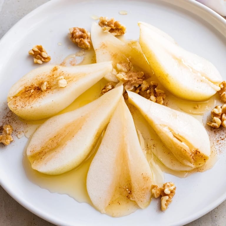 Fresh pear slices drizzled with golden honey, a simple and elegant appetizer.