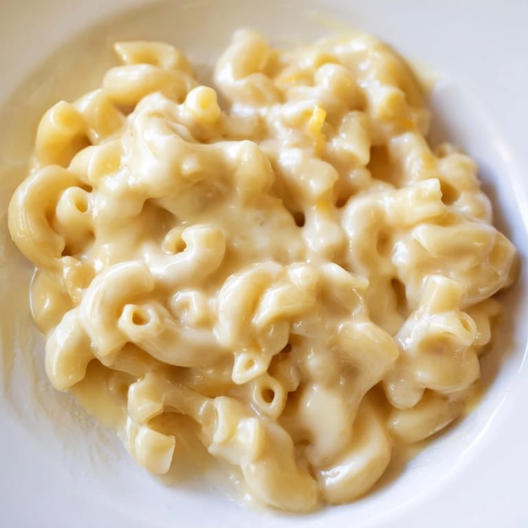Golden baked mac and cheese bubbling in a dish; a classic comfort food recipe.