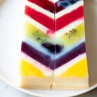 Vibrant The Kaleidoscope dessert with layers of color and fruit puree, perfect for serving.